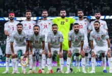 football team stands together for a cheerful group photo, showcasing their camaraderie and pride