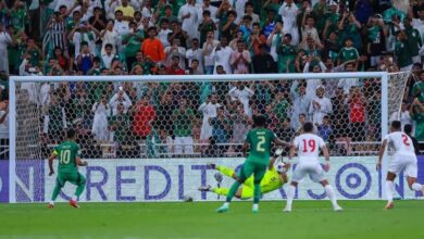 A soccer player leaps into the air, ready to strike the ball with precision and power.