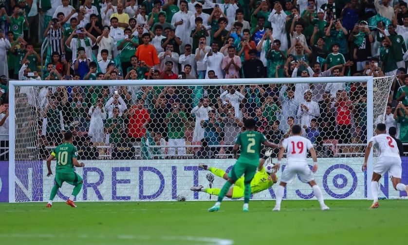 A soccer player leaps into the air, ready to strike the ball with precision and power.