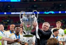 Carlo Ancelotti proudly holds a Champions League Trophy