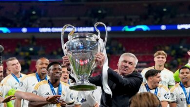 Carlo Ancelotti proudly holds a Champions League Trophy