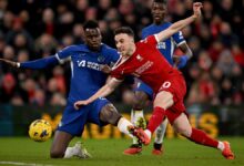 Liverpool's Player and Chelsea's Player face off during an intense match, showcasing their athleticism