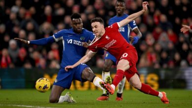 Liverpool's Player and Chelsea's Player face off during an intense match, showcasing their athleticism