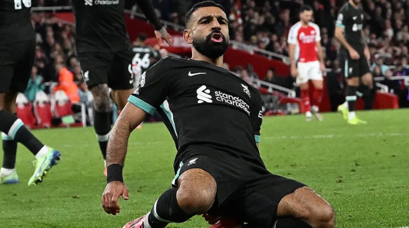 Salah celebrates triumphantly after scoring a goal for Liverpool against Arsenal