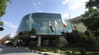 "CAF headquarters with flags and modern glass building."