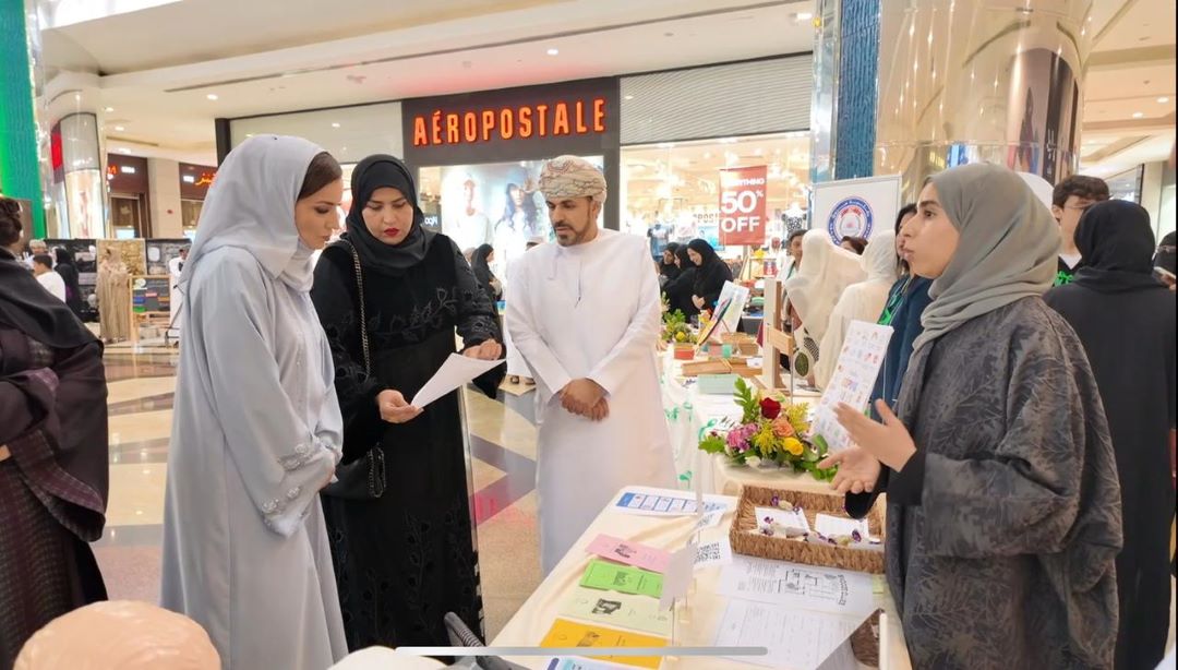 "People at an informational booth in a shopping mall."