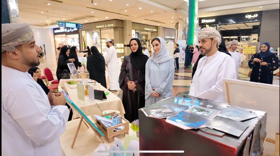 "People at a market stall in a shopping mall."