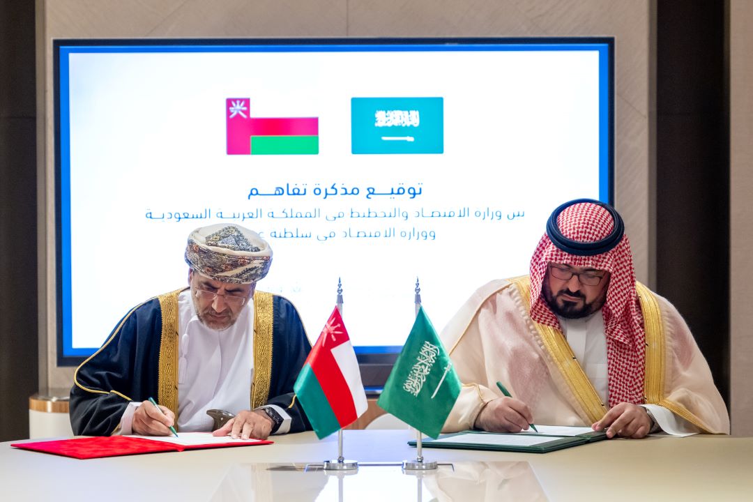 "Oman and Saudi officials sign a memorandum of understanding during a formal meeting."