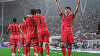 "Soccer player celebrating goal in red jersey number 10."