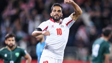 "Soccer player celebrating goal in white jersey number 10."