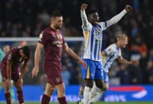 Brighton players celebrate the win amid the disappointment of City players