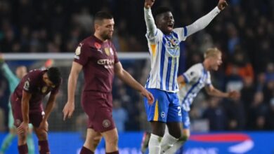 Brighton players celebrate the win amid the disappointment of City players