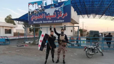 Syrian opposition fighters in front of the Nassib border crossing